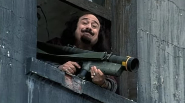 Danny DeVito holds a bazooka