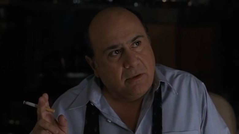 Danny DeVito smokes a cigarette