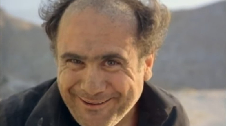 A dirty Danny DeVito grins