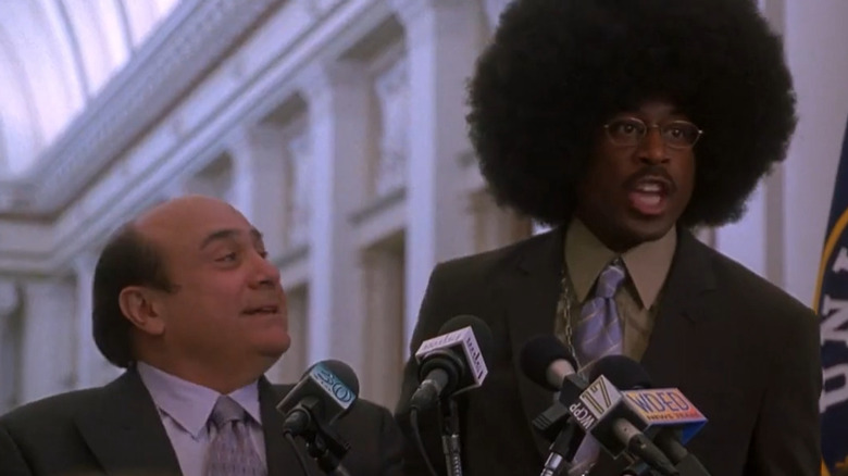 Danny DeVito looks at Martin Lawrence wearing a large wig