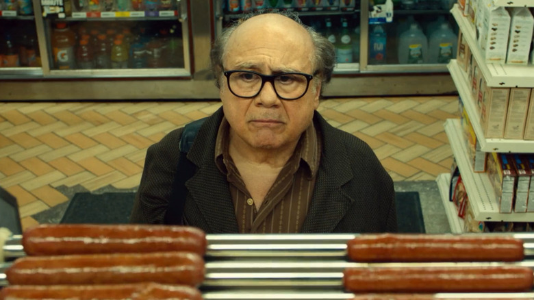 Danny DeVito stares sadly at hot dogs