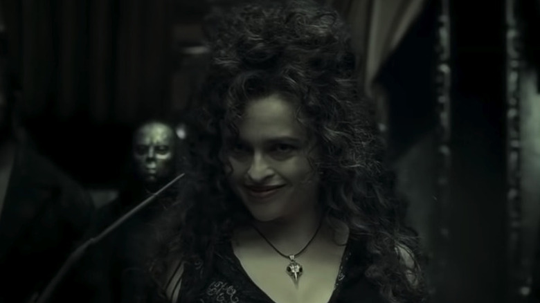 Bellatrix holds wand and smiles 