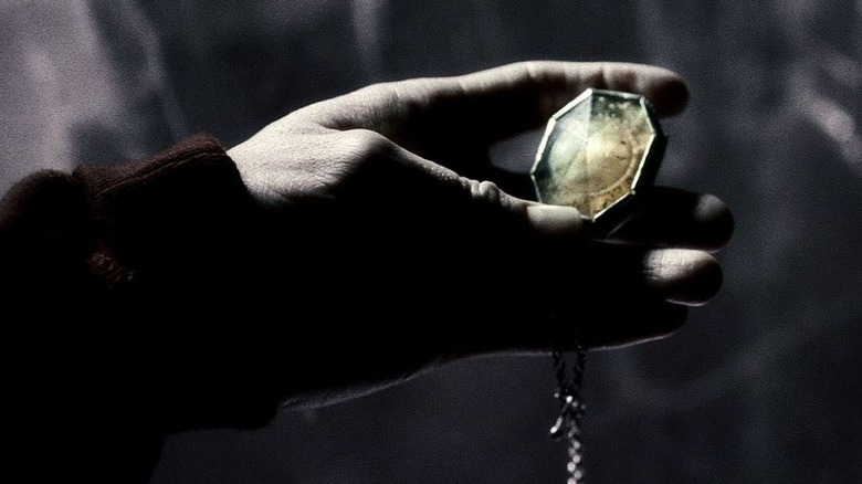 Harry Potter holds Salazar Slytherin's locket