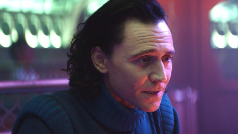 Loki sitting in bisexual lighting