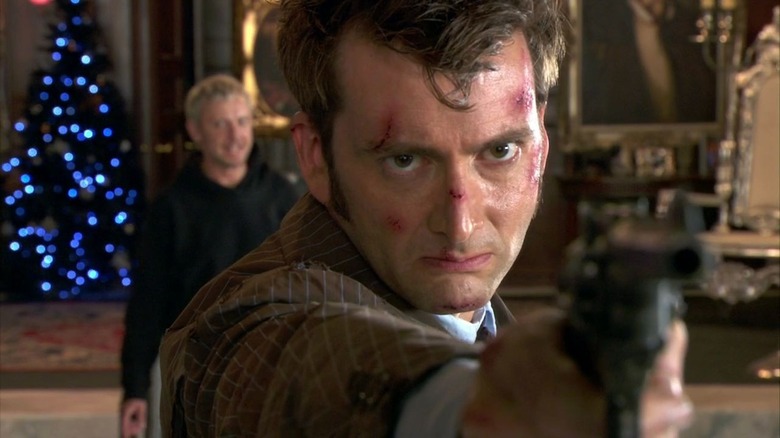 The Doctor aims a gun