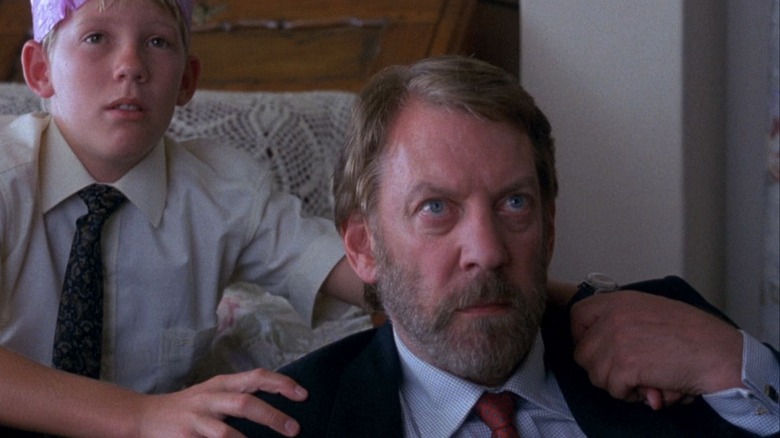 Donald Sutherland and boy watching TV