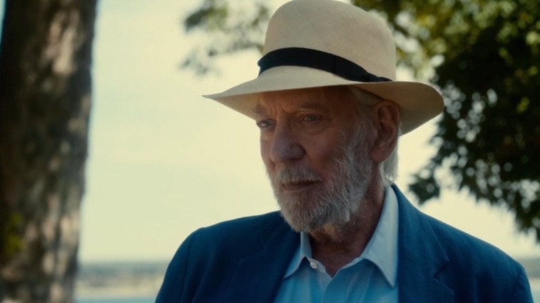 Donald Sutherland wearing fedora and blue suit