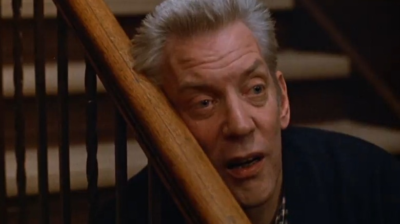 Donald Sutherland resting head on handrail