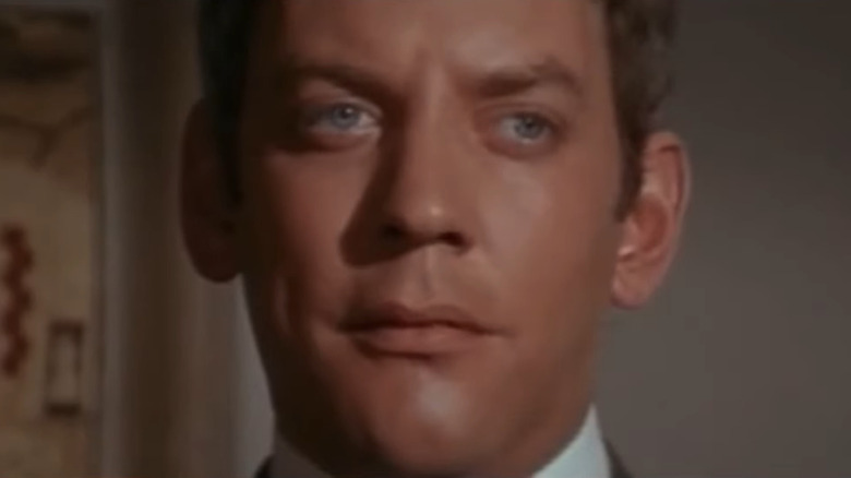Younger Donald Sutherland staring