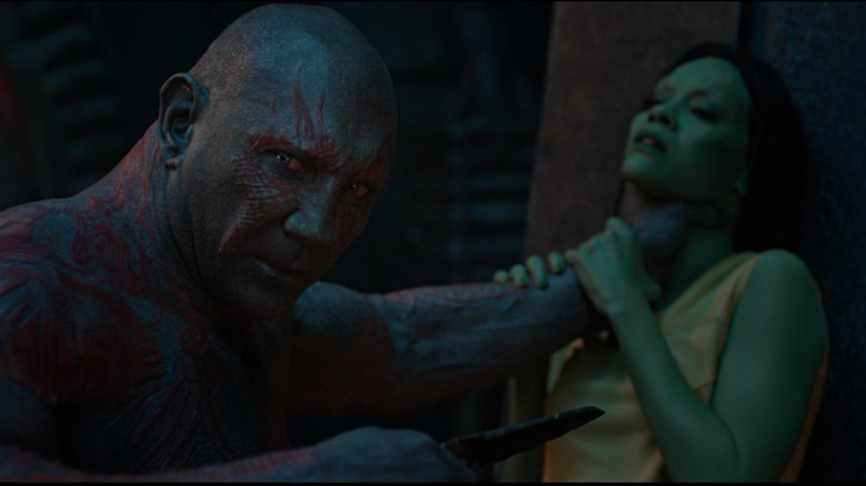 Drax points a knife at Gamora