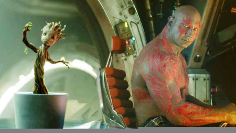 Drax looks at Baby Groot