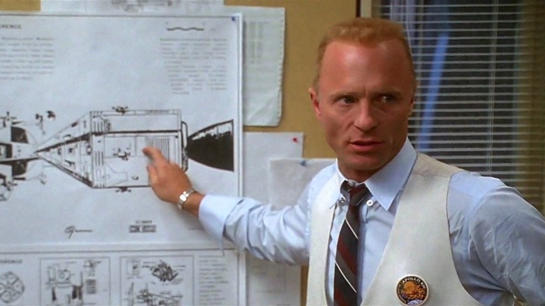 Ed Harris points to a diagram