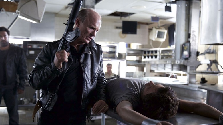 Ed Harris holds a gun