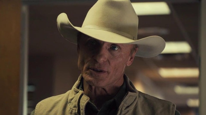 Ed Harris wears a cowboy hat