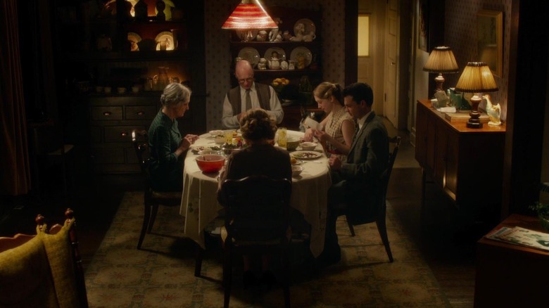 Ed Harris sits at the dinner table