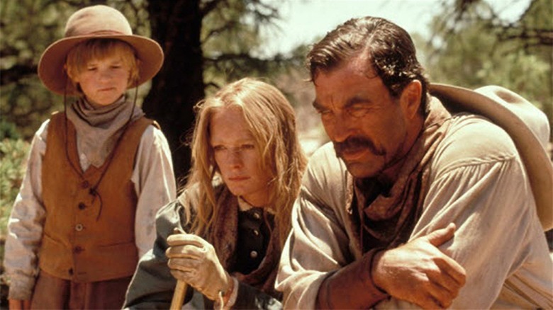 Paul, Martha, and Davis sit in the grass