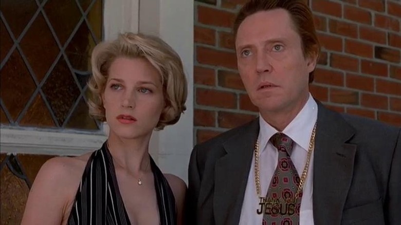 Bridget Fonda and Christopher Walken stand by a door