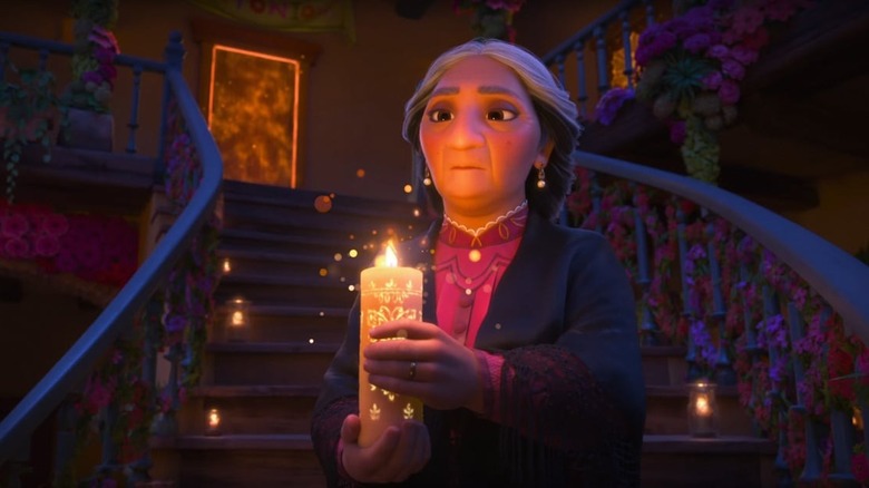 Alma Madrigal holding magical candle