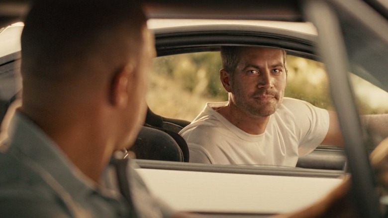 Two men look at each other through car windows