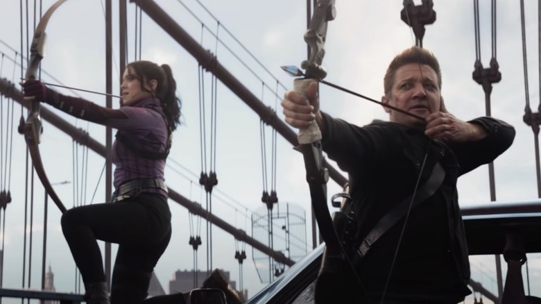 Clint and Kate firing arrows on a bridge Hawkeye