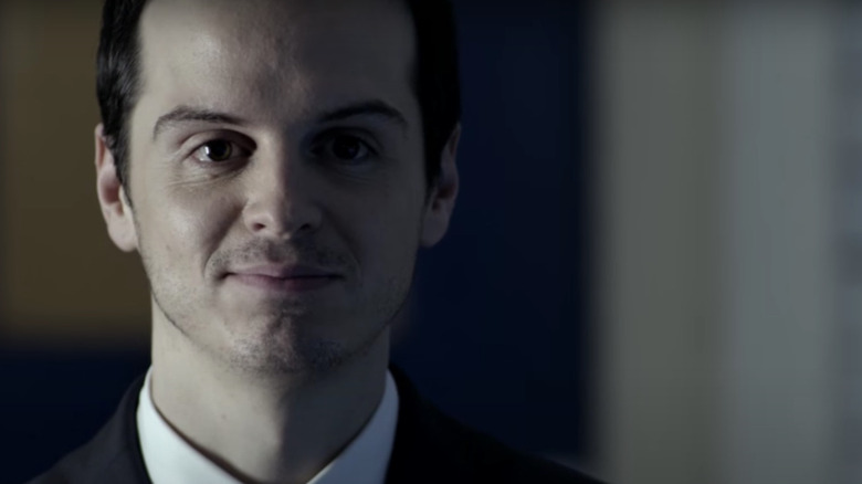 Jim Moriarty wearing suit