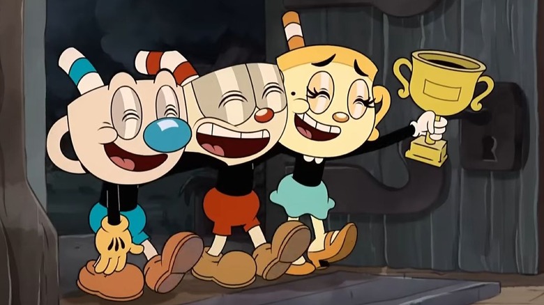 Cuphead, Mugman, and Ms. Chalice winning a trophy