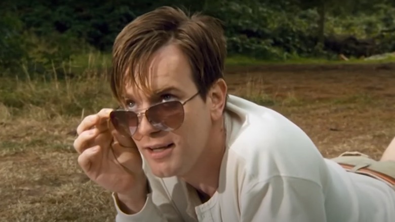 Ewan McGregor peers over sunglasses