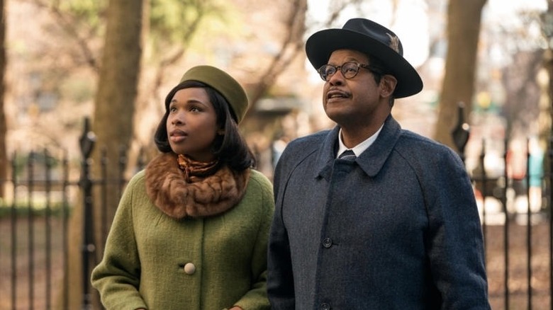 Young Aretha Franklin standing with her father