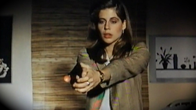 Woman holding a rubber dart gun