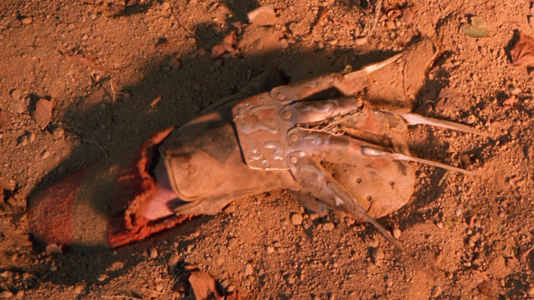 Freddy Krueger's hand grabs hockey mask