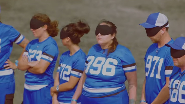 Beast Games contestants wearing blindfolds