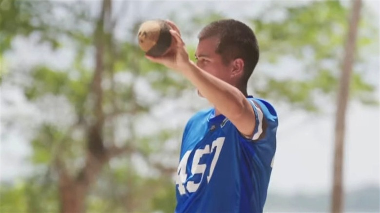 Player 457 holding up a coconut on Beast Games