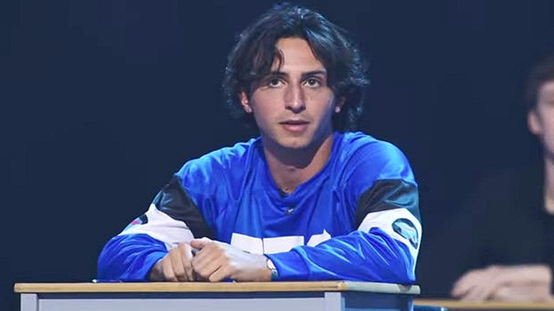 Contestant sitting at a desk on Beast Games