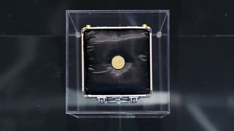 Beast Games coin inside briefcase