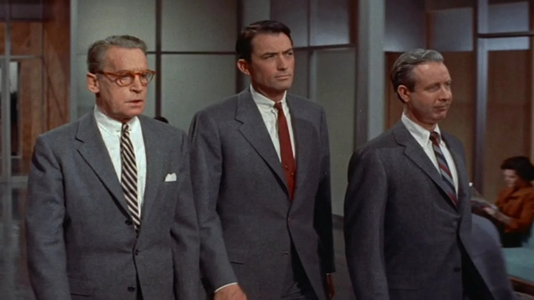 Three businessmen walk through an office