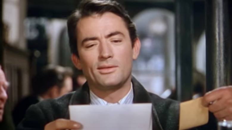 Peck holds an envelope