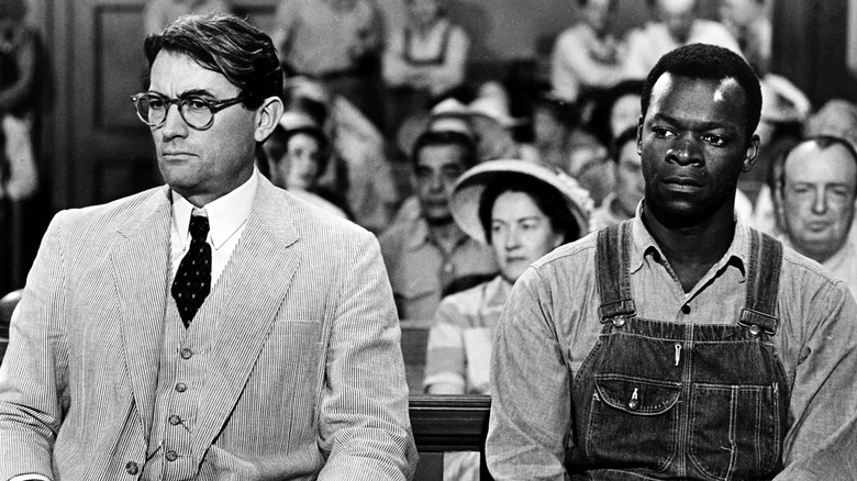 Atticus sits with Tom Robinson in court