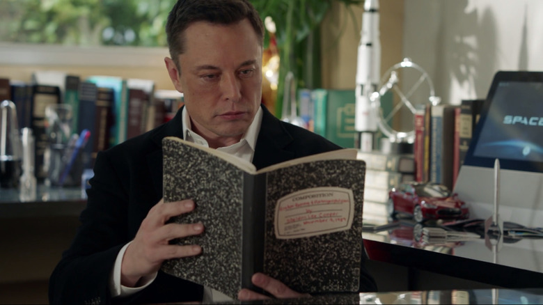 Elon Musk reading notebook