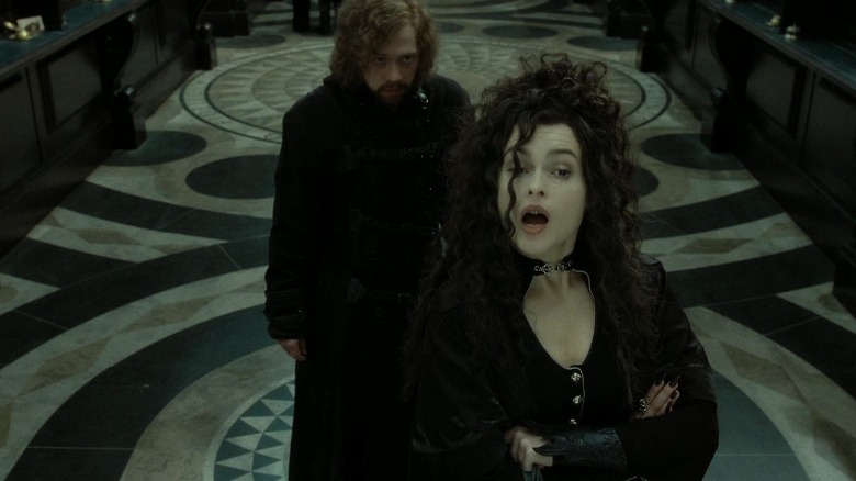 Hermoine disguised as Bellatrix and crossing her arms in defiance