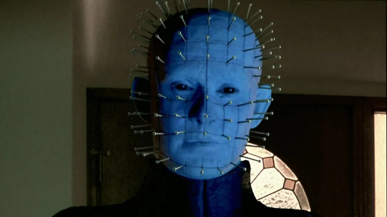 Pinhead in front of a door