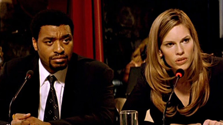 Hilary Swank and Chiwetel Ejiofor sitting in front of microphones