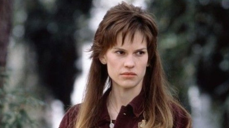 Hilary Swank with a mullet looking angry