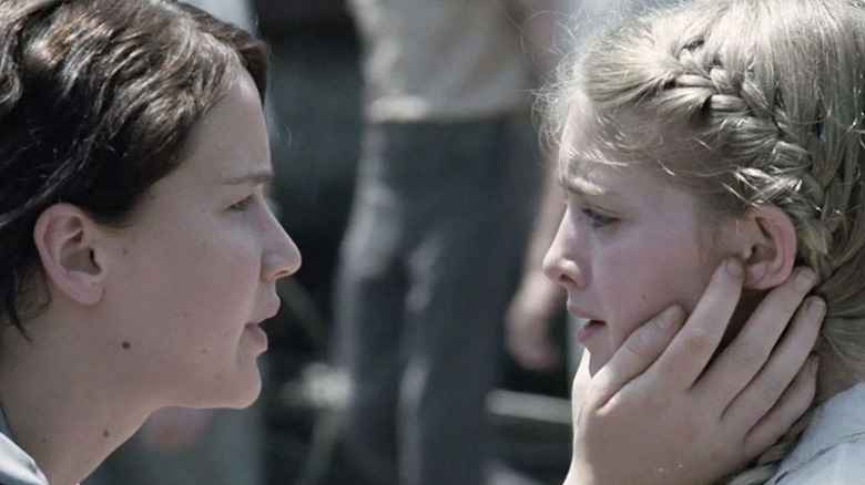 Katniss cupping Prim's face