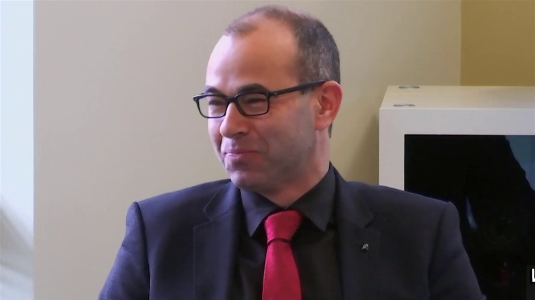 Murr at desk laughing