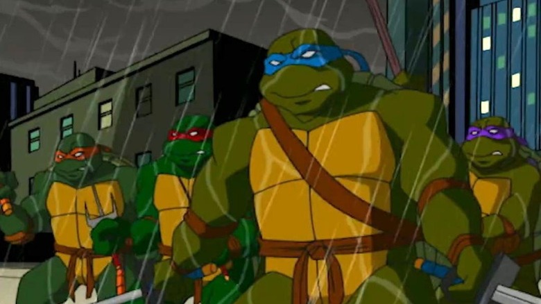 The Ninja Turtles draw weapons