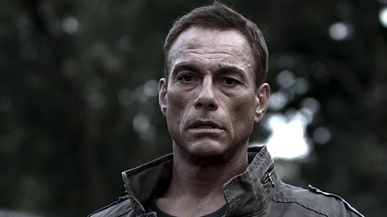 Van Damme in the woods in a jacket