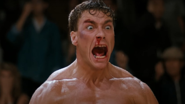 Van Damme screams, bleeding from his nose