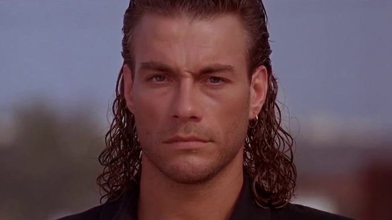 Jean-Claude Van Damme with long, slick hair