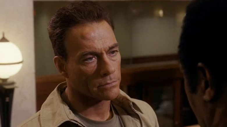 Jean-Claude Van Damme staring down a man