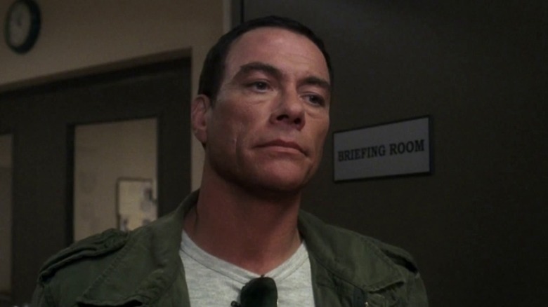 Jean-Claude Van Damme outside a briefing room